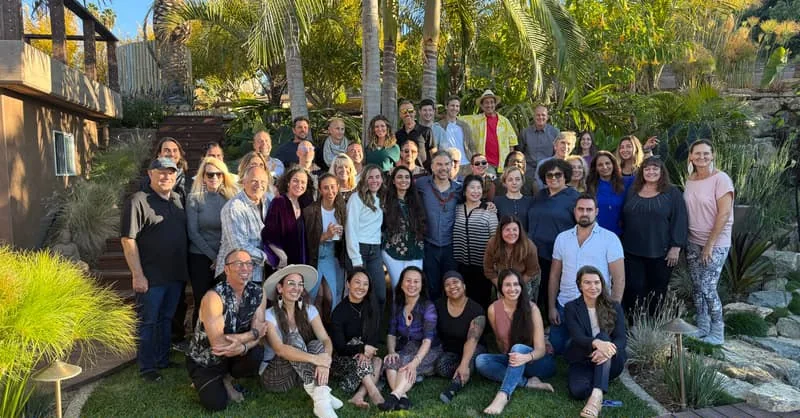 A large retreat community gathered together outdoors at The ARC